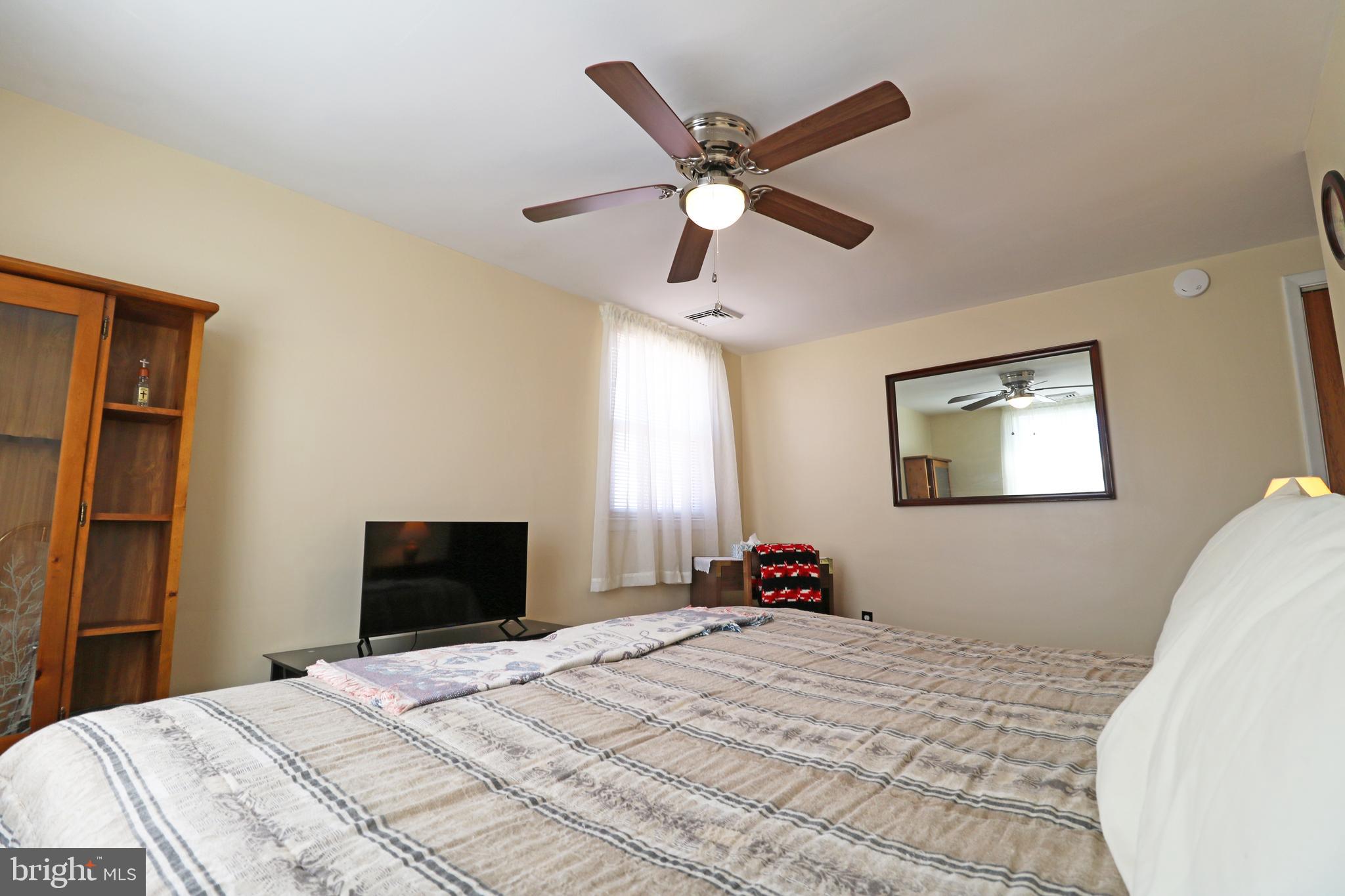 716 Cambridge Road Brookhaven, PA 19015 - Photo 19 of 42 a bedroom with a bed and a chandelier