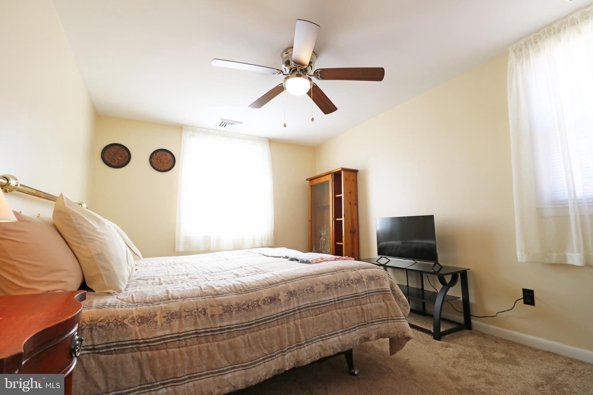 716 Cambridge Road Brookhaven, PA 19015 - Photo 20 of 42 a bedroom with a bed and a flat screen tv