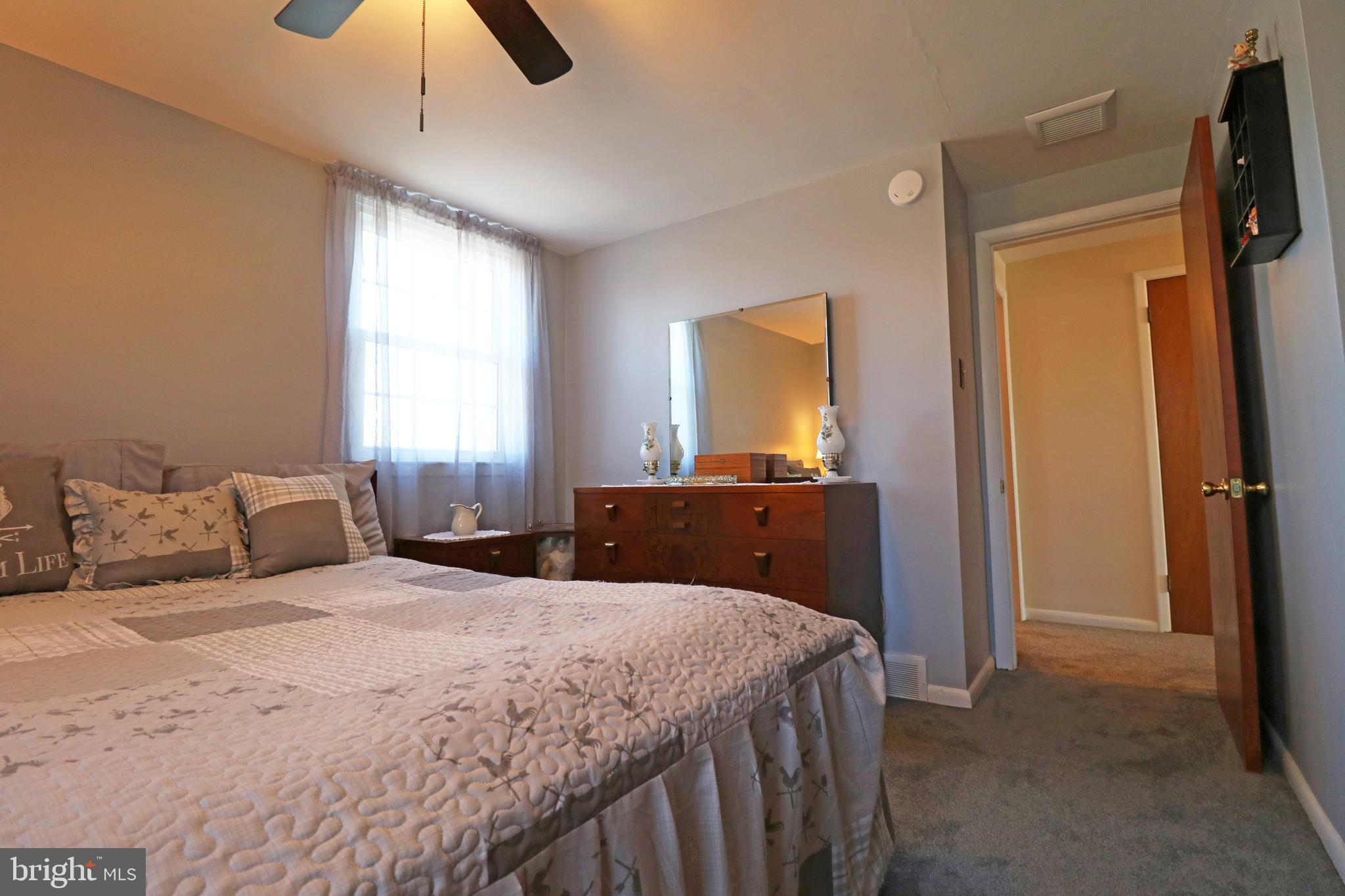 716 Cambridge Road Brookhaven, PA 19015 - Photo 22 of 42 a bedroom with a bed and a chandelier