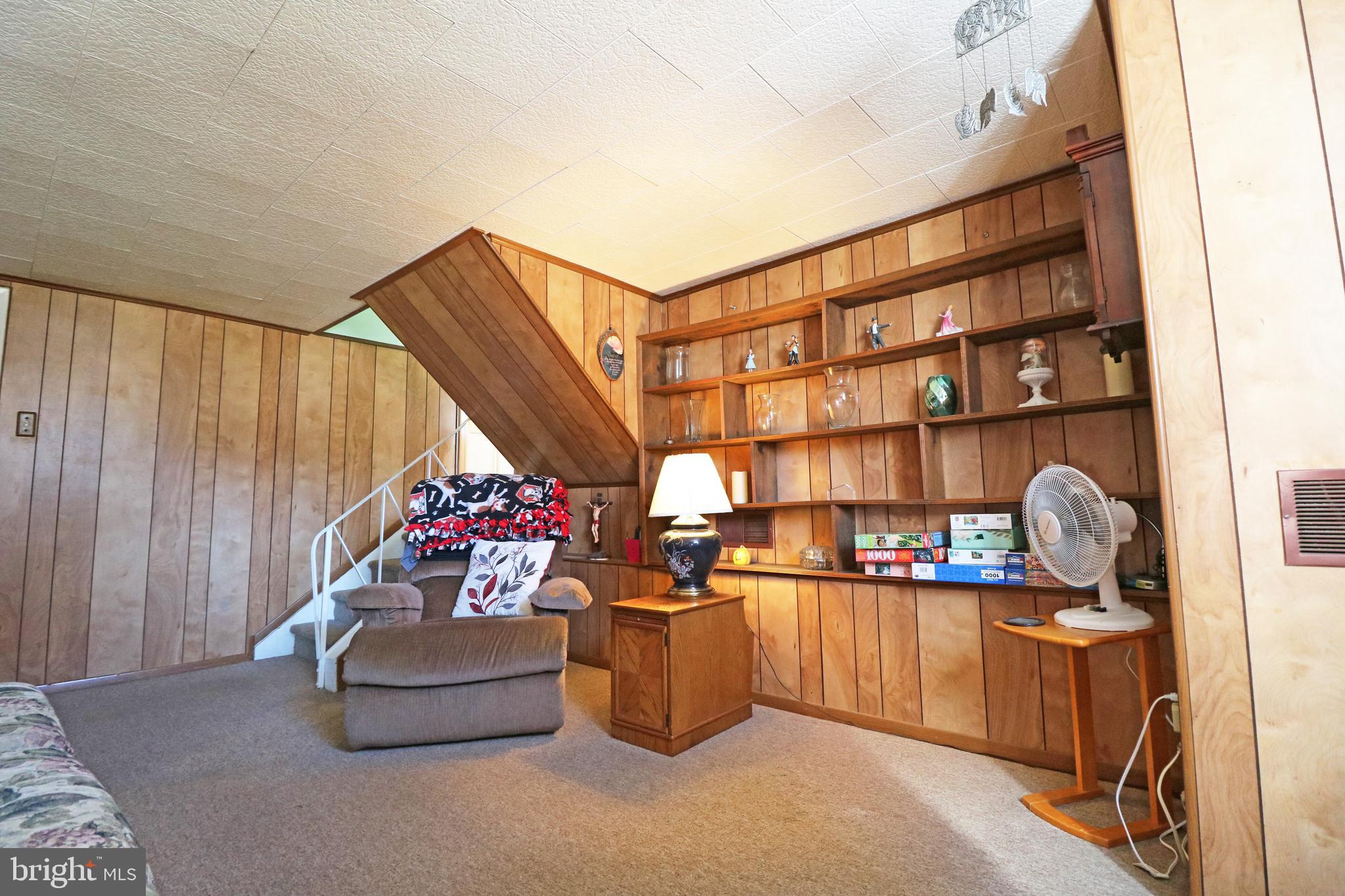 716 Cambridge Road Brookhaven, PA 19015 - Photo 25 of 42 a room with lots of books and a view of living room