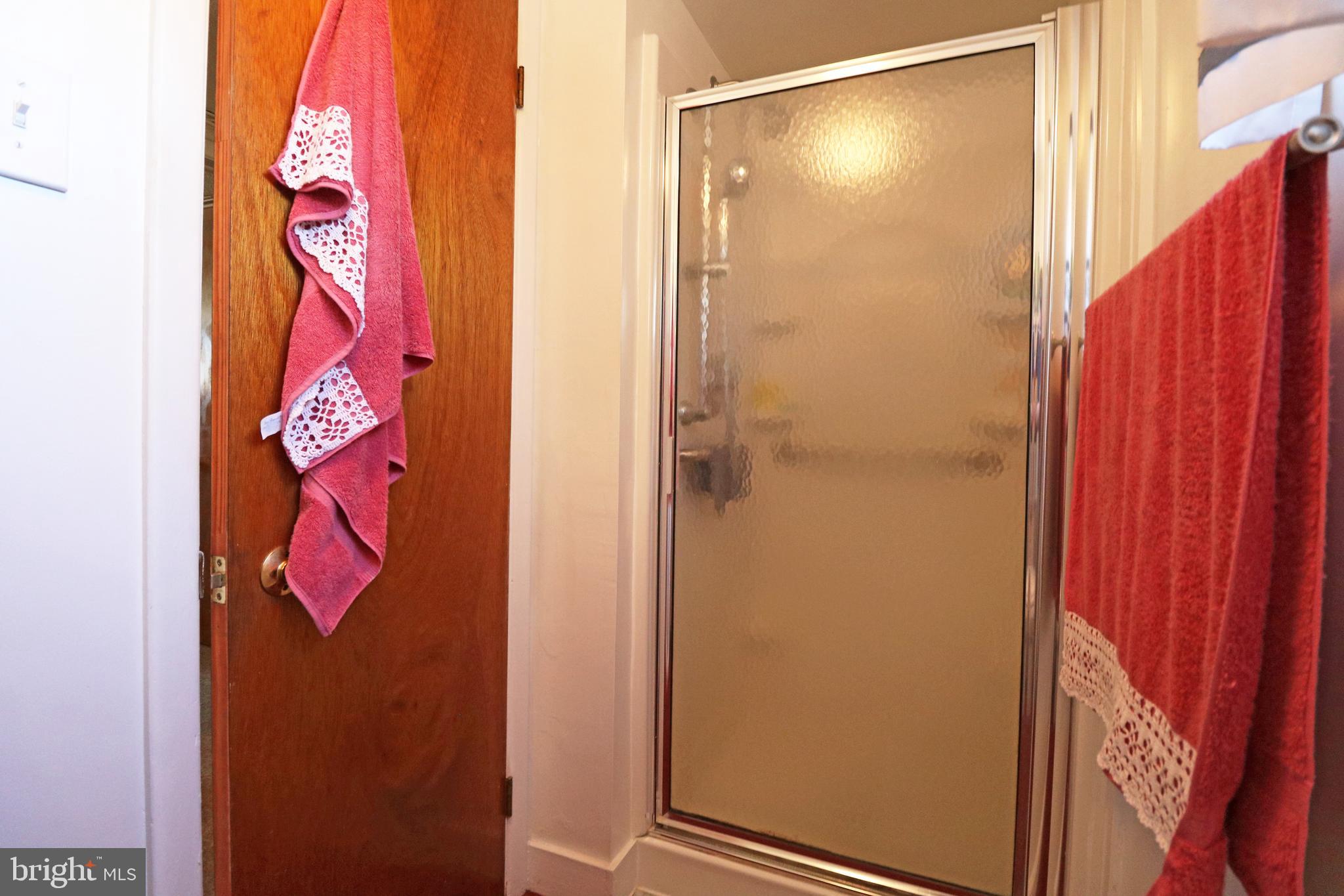 716 Cambridge Road Brookhaven, PA 19015 - Photo 28 of 42 a bathroom with a shower and a door