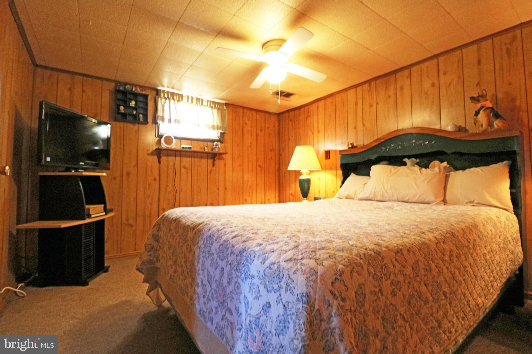 716 Cambridge Road Brookhaven, PA 19015 - Photo 34 of 42 a bedroom with a bed and a flat screen tv