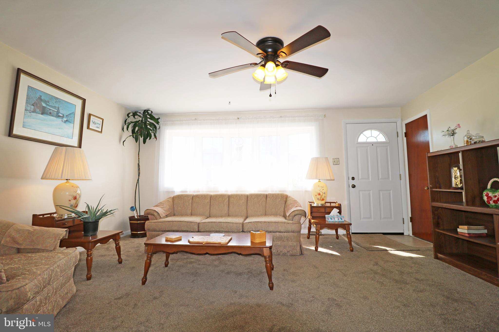 716 Cambridge Road Brookhaven, PA 19015 - Photo 8 of 42 a living room with furniture and a flat screen tv