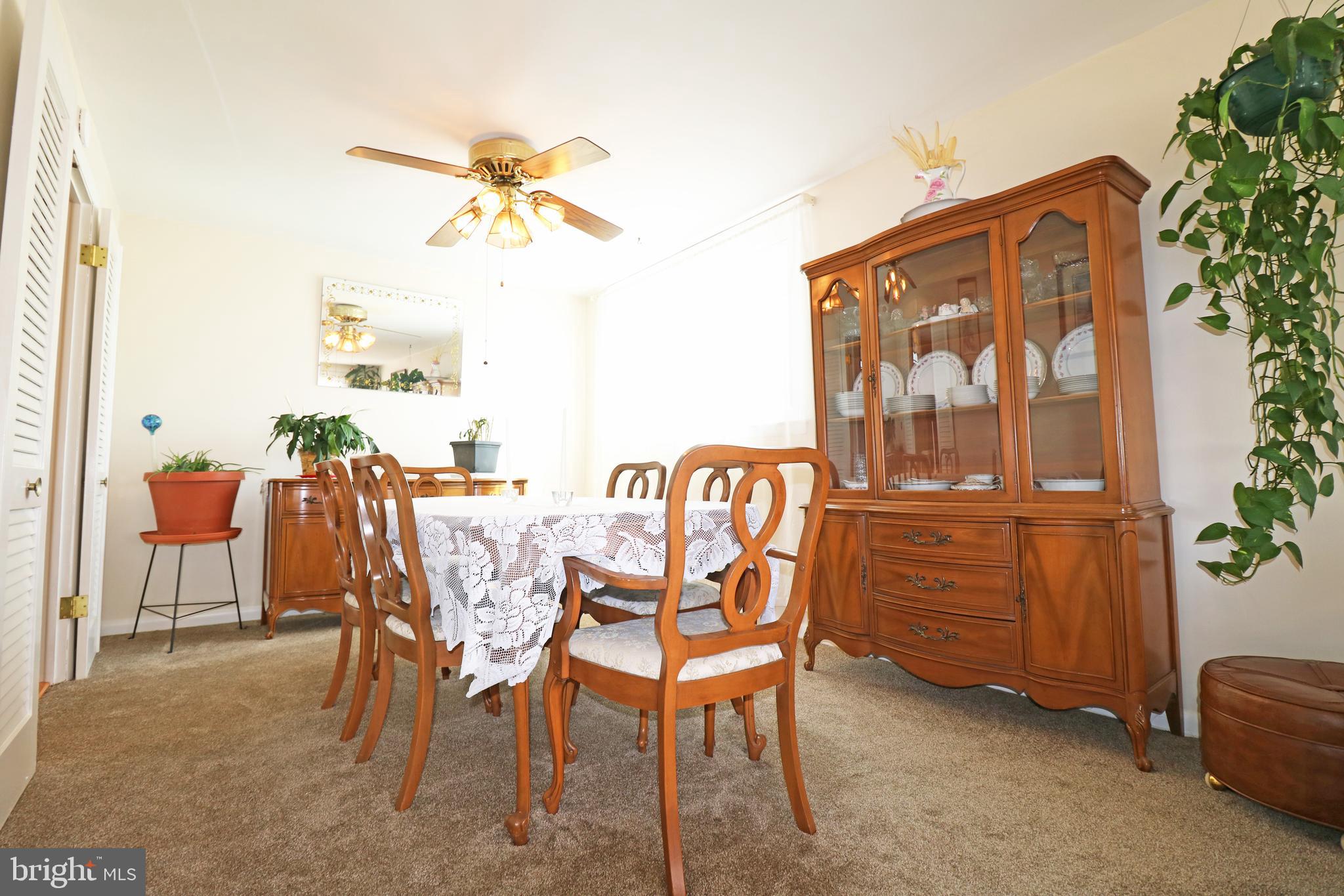 716 Cambridge Road Brookhaven, PA 19015 - Photo 9 of 42 a dining room with furniture a chandelier and a window