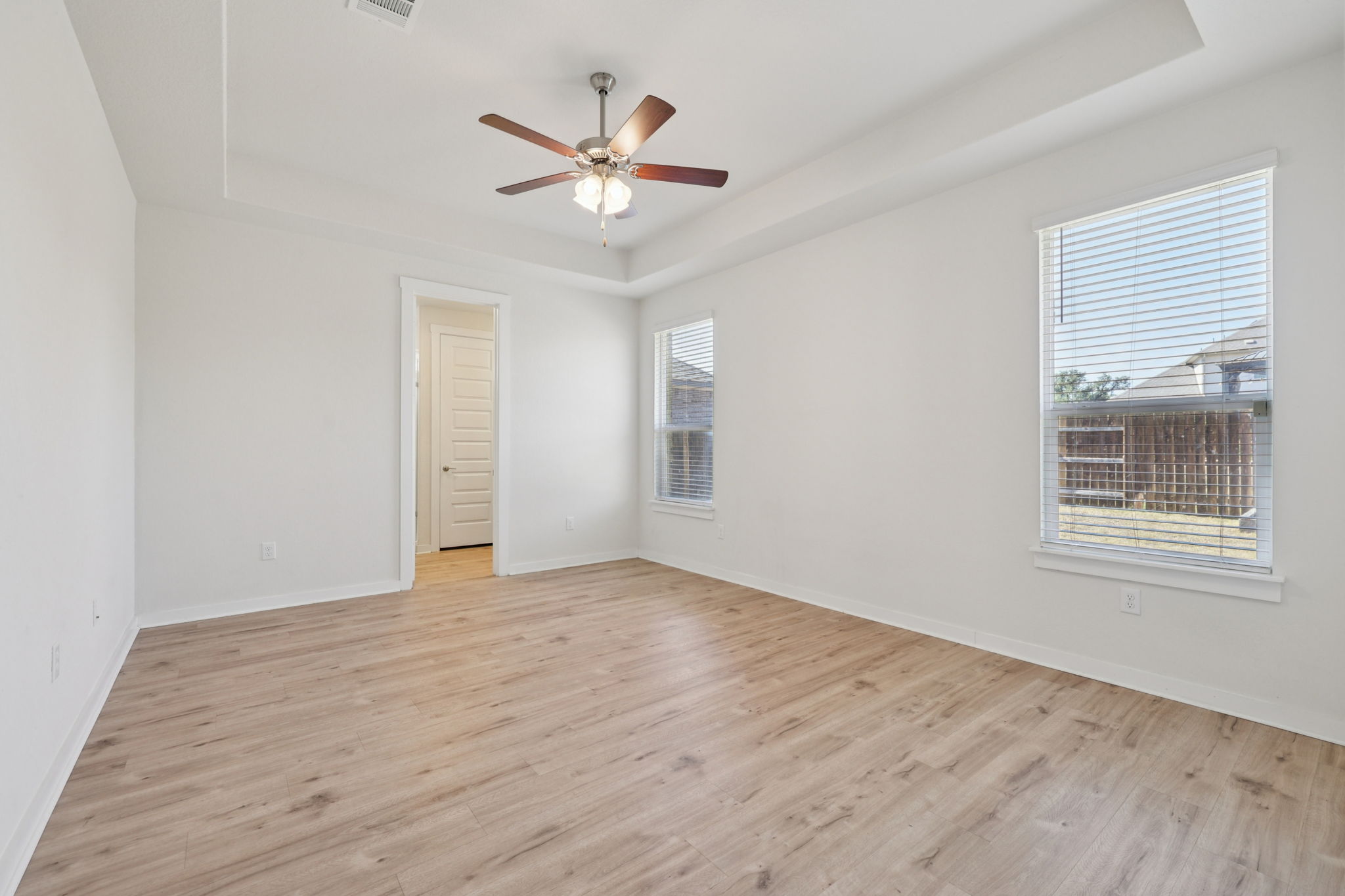 1024 Bear Track Loop Georgetown, TX 78628 - Photo 12 of 35 a view of an empty room with wooden floor and a window