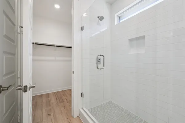 a view of a big room with wooden floor closet and fan