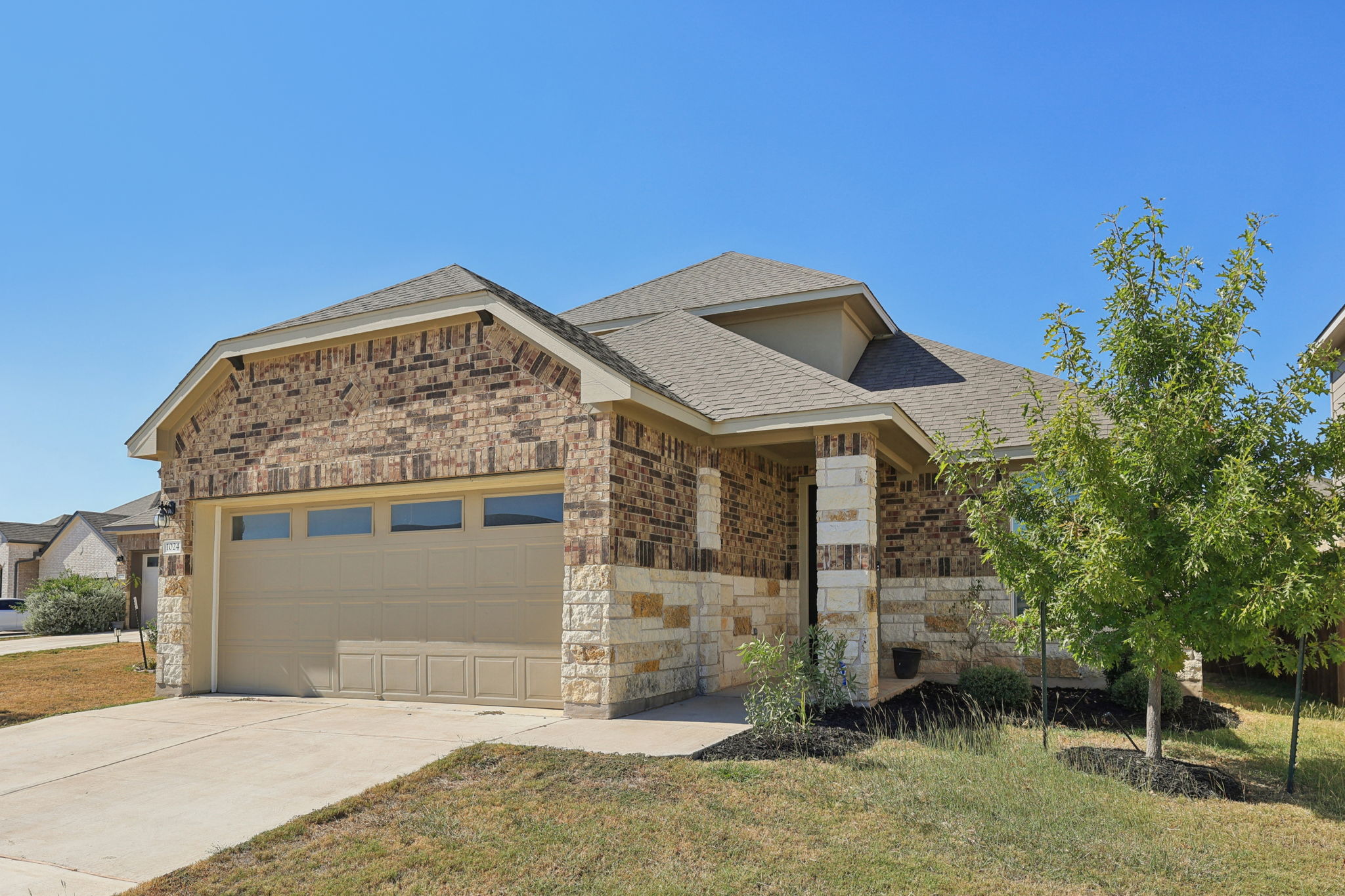 1024 Bear Track Loop Georgetown, TX 78628 - Photo 2 of 35 a front view of a house with a yard