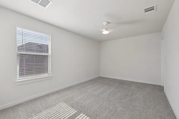 a view of a livingroom with a ceiling fan and window