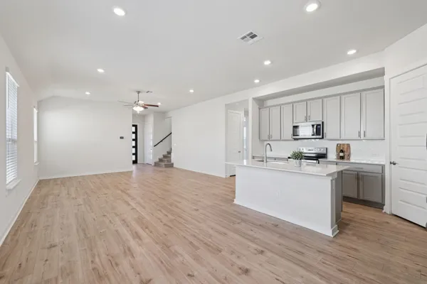a view of a kitchen with a sink and a refrigerator