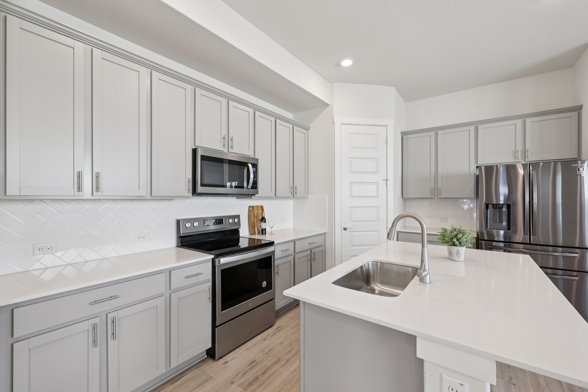 1024 Bear Track Loop Georgetown, TX 78628 - Photo 10 of 35 a kitchen with a sink stainless steel appliances and cabinets