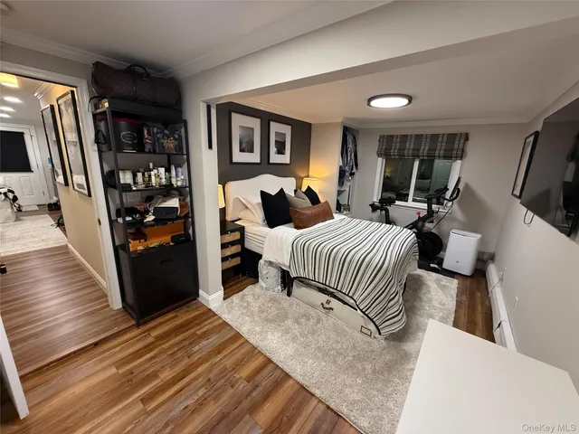 a bedroom with bed and wooden floor