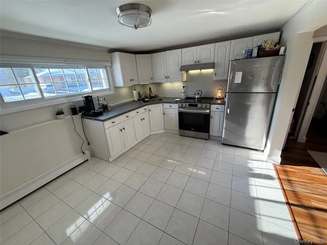 a kitchen with stainless steel appliances granite countertop a refrigerator sink and cabinets