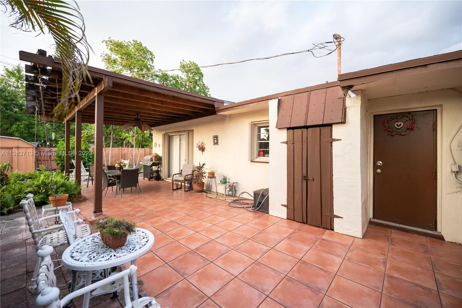 Hialeah Hialeah, FL 33012 - Photo 3 of 17 a backyard of a house with seating space