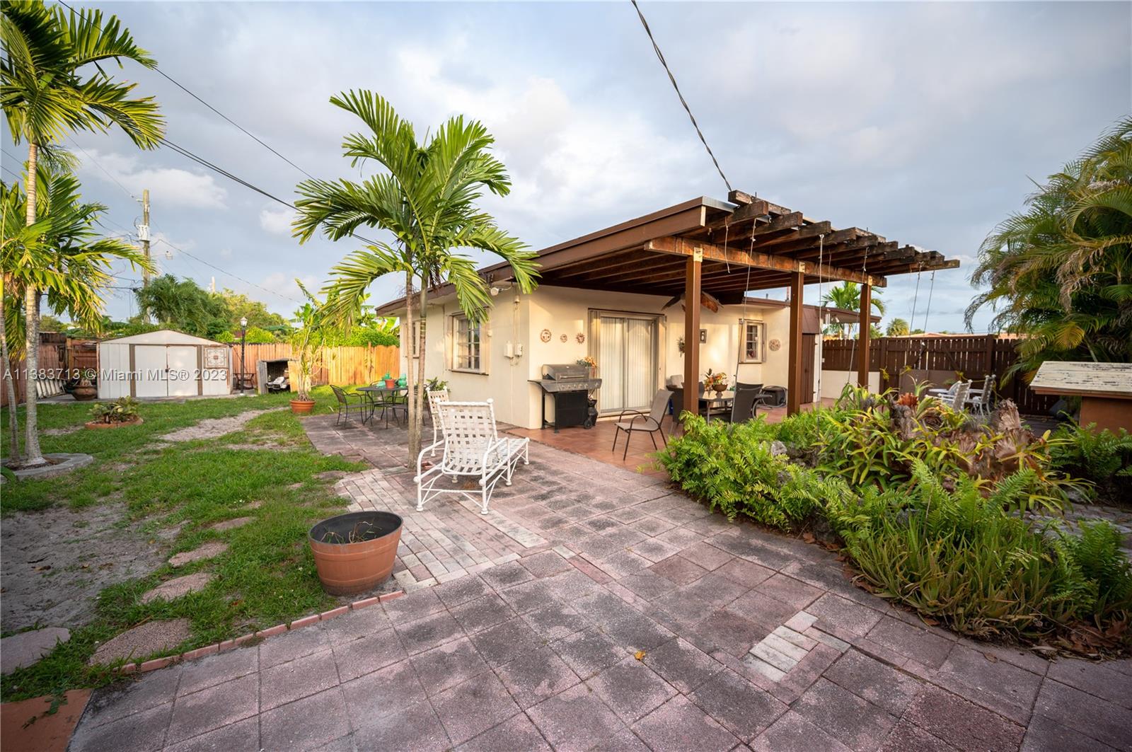 Hialeah Hialeah, FL 33012 - Photo 5 of 17 a view of a chair and table in backyard of the house