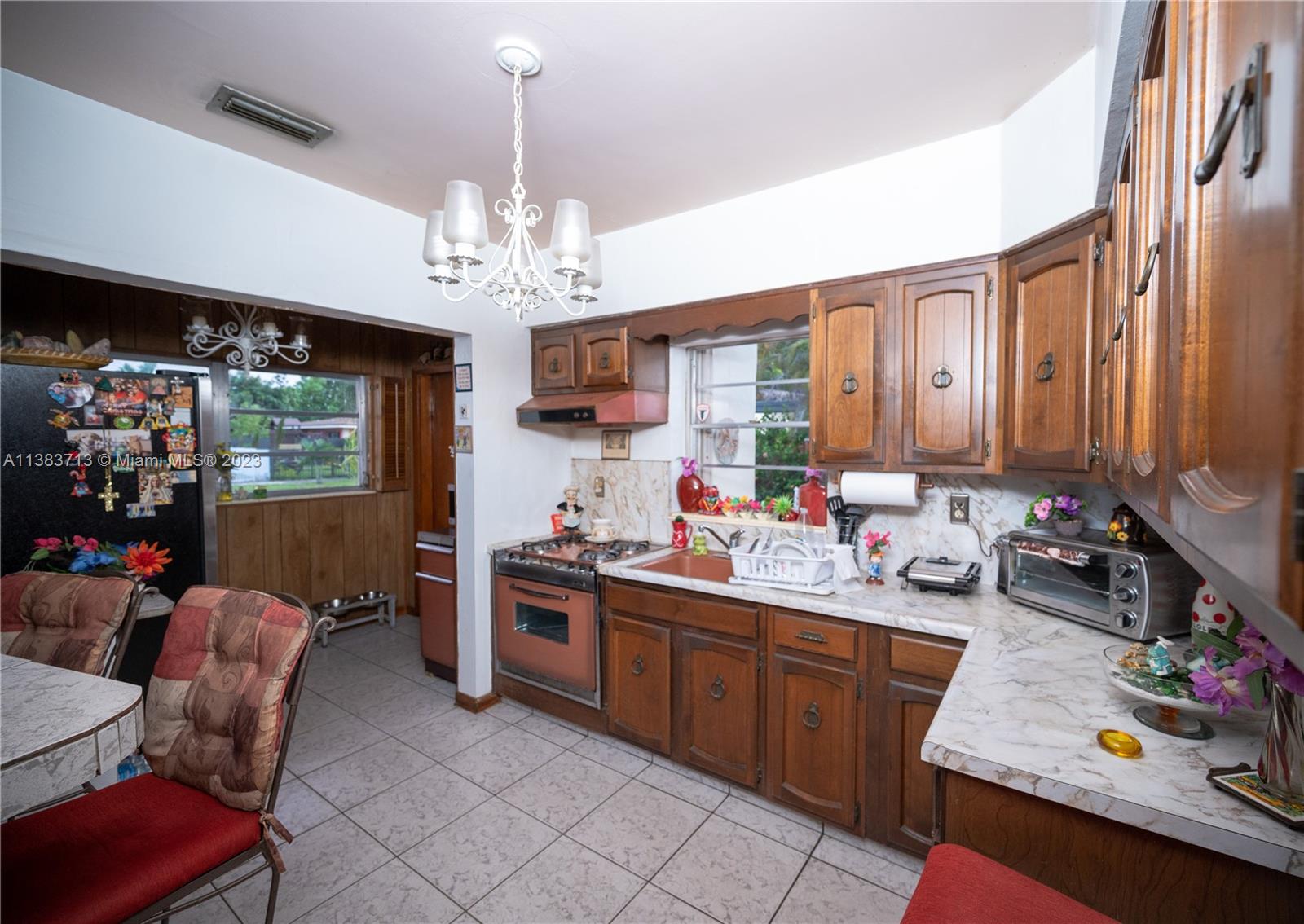 Hialeah Hialeah, FL 33012 - Photo 9 of 17 a kitchen with a sink stove and cabinets