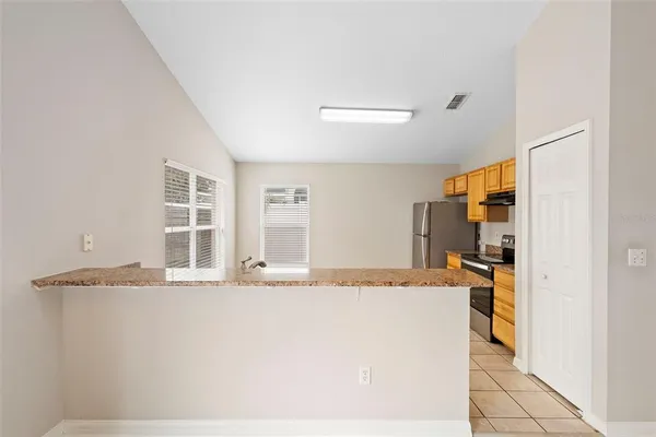 a view of a kitchen with granite countertop cabinets