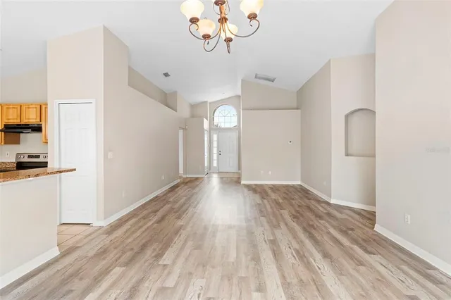 a view of a room with wooden floor
