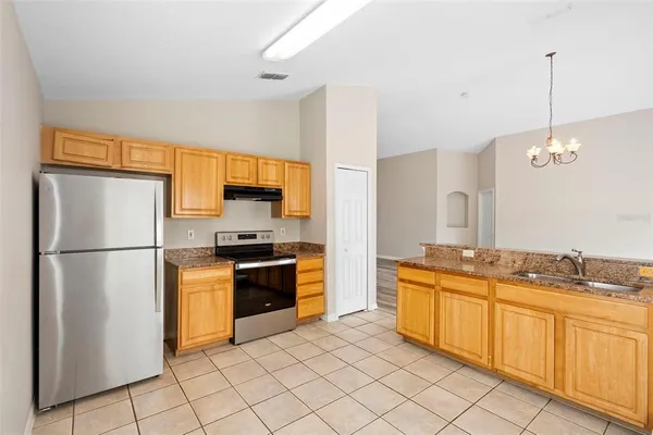 a kitchen with cabinets a sink and stainless steel appliances