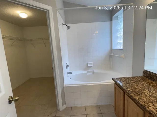 a bathroom with a granite countertop sink a toilet and shower