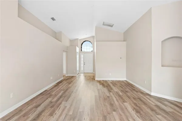 a view of a room with wooden floor and white walls