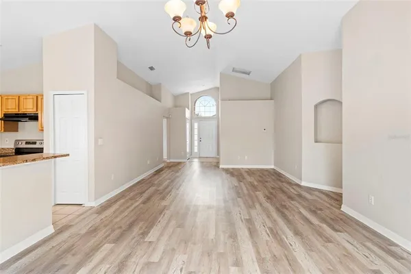a view of a room with wooden floor