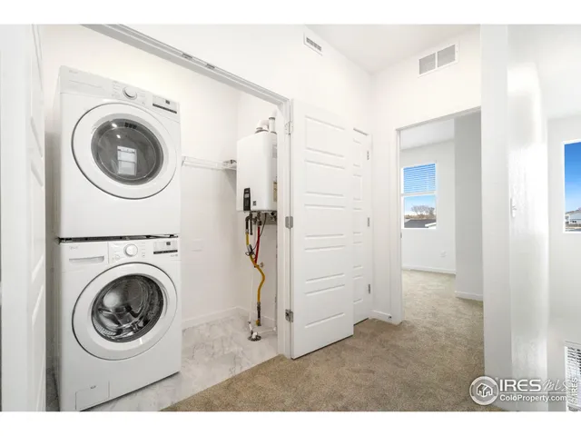 a view of a hallway with washer and dryer