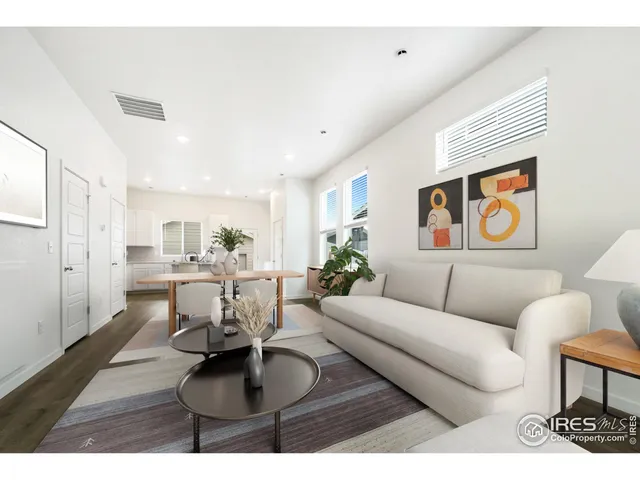 a living room with furniture and a dining table