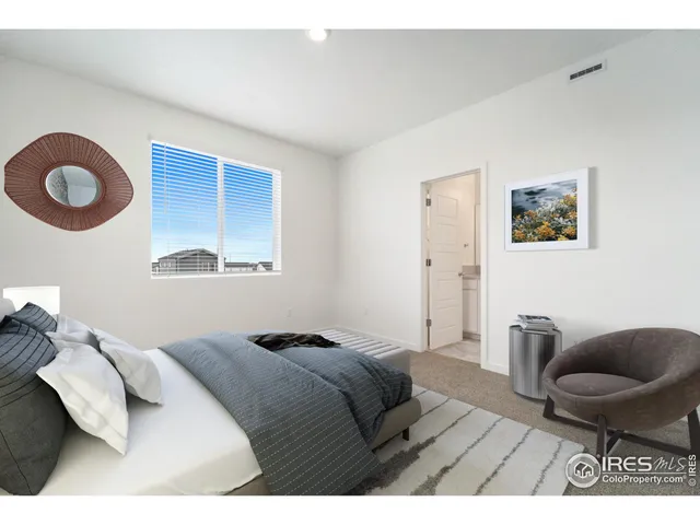 a bedroom with a bed and chair