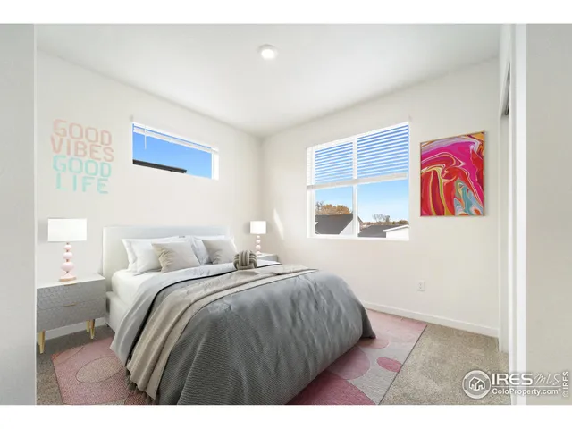 a bedroom with a bed and a painting on the wall