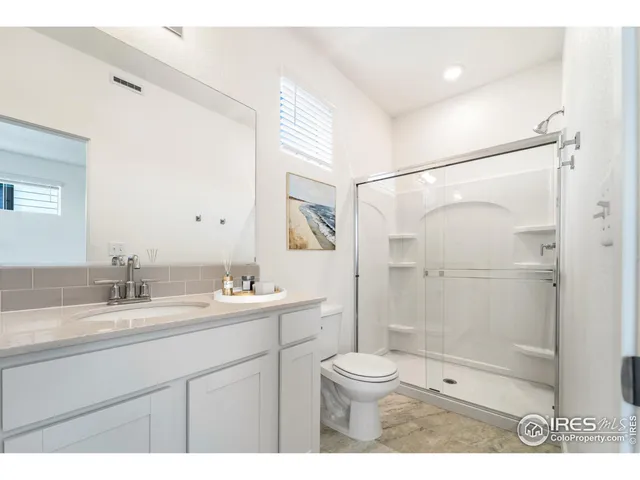 a bathroom with a sink toilet a mirror and shower