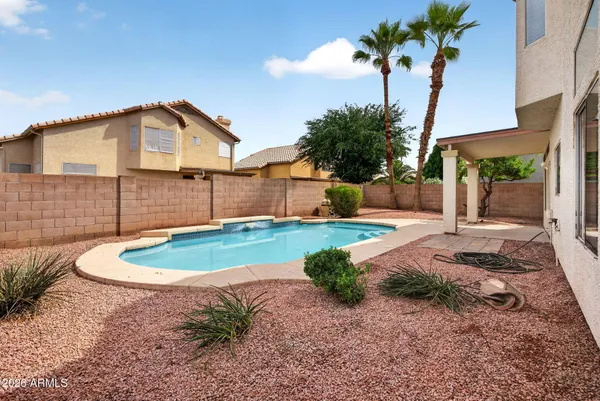 a view of a swimming pool with a yard
