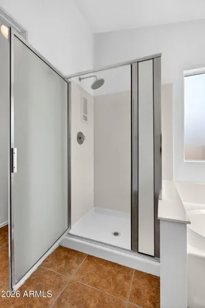 a spacious bathroom with a double vanity sink mirror and bathtub