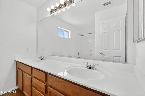 an empty room with window and ceiling fan