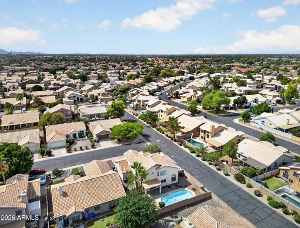 an aerial view of residential houses with outdoor space