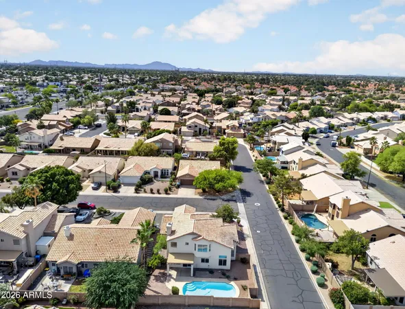 an aerial view of residential houses with outdoor space