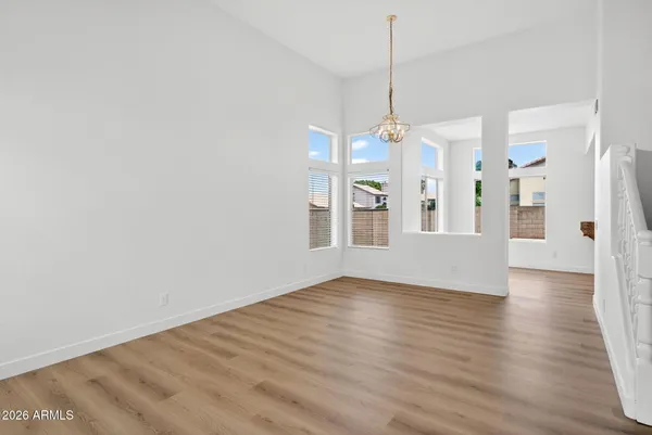 a view of a livingroom with wooden floor and a ceiling fan