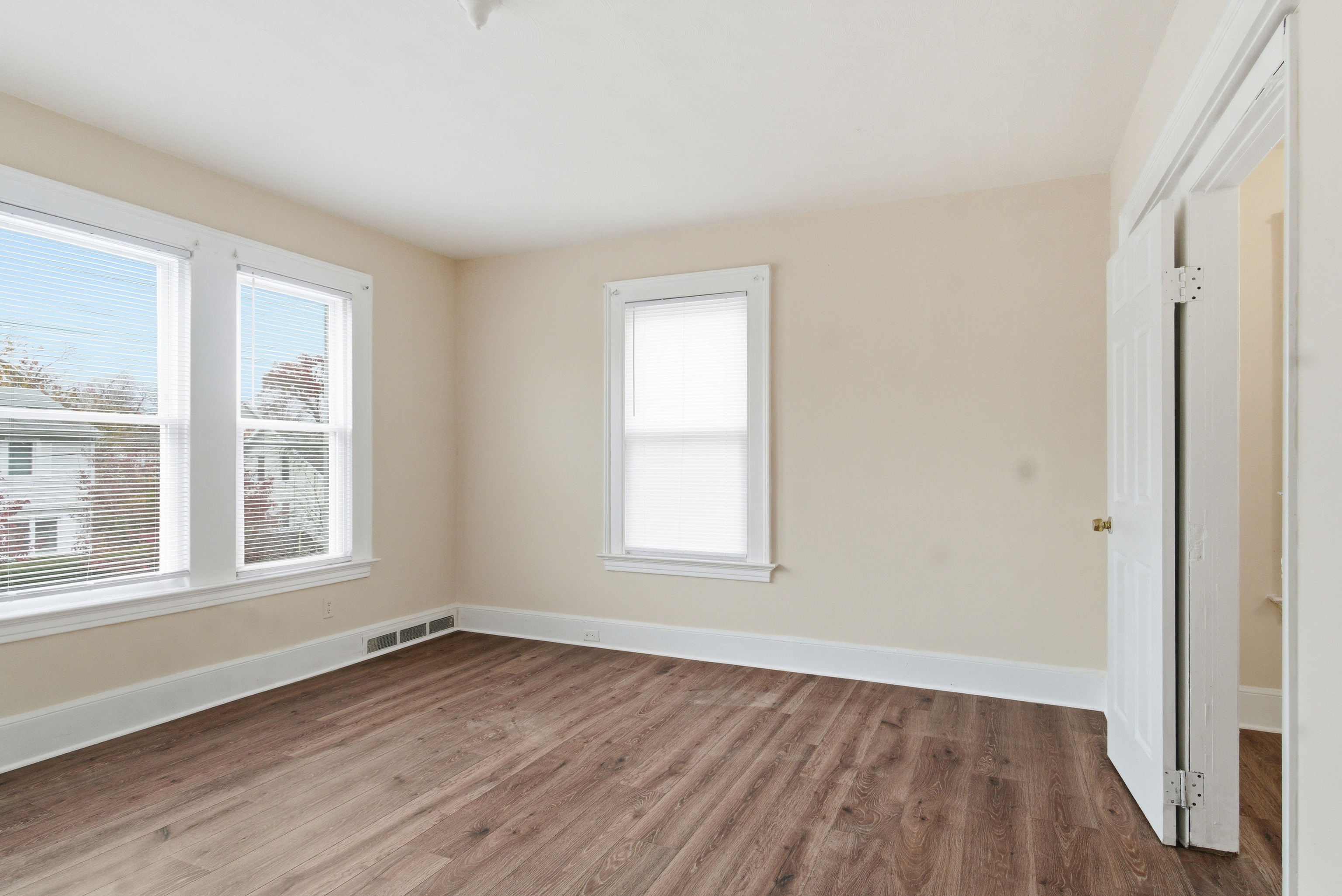 46 Court Street, Unit 2 West Haven, CT 06516 - Photo 2 of 9 an empty room with wooden floor and windows