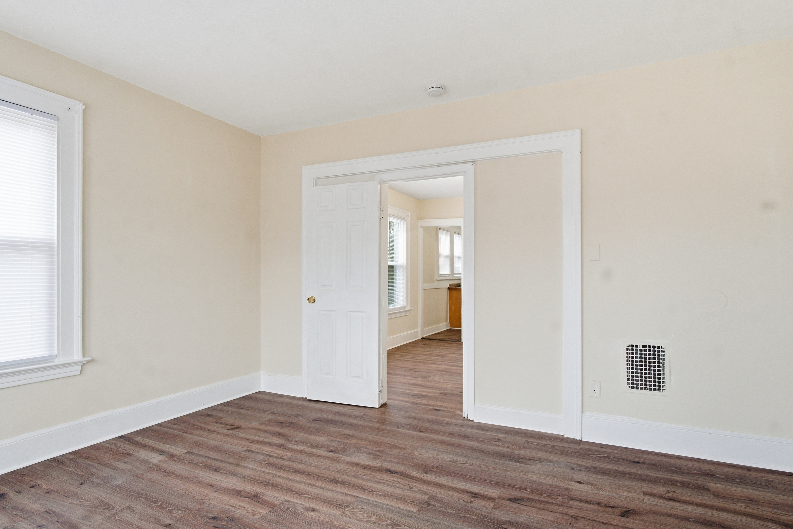 46 Court Street, Unit 2 West Haven, CT 06516 - Photo 3 of 9 a view of an empty room with wooden floor and a window