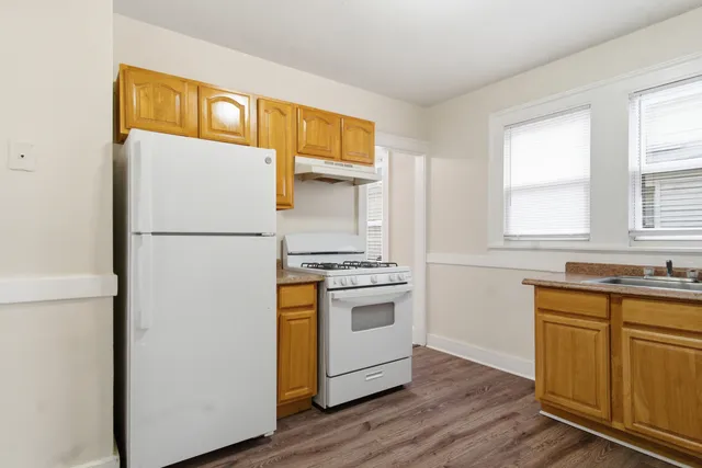a kitchen with a refrigerator and a sink