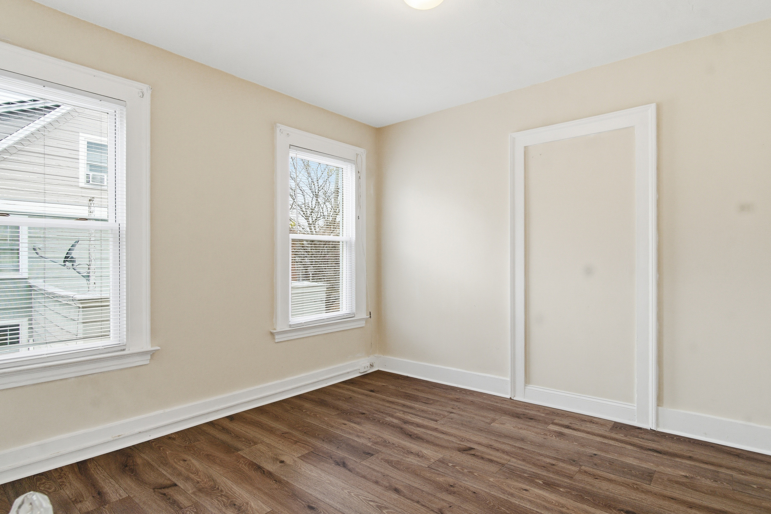 46 Court Street, Unit 2 West Haven, CT 06516 - Photo 6 of 9 a view of an empty room with wooden floor and a window