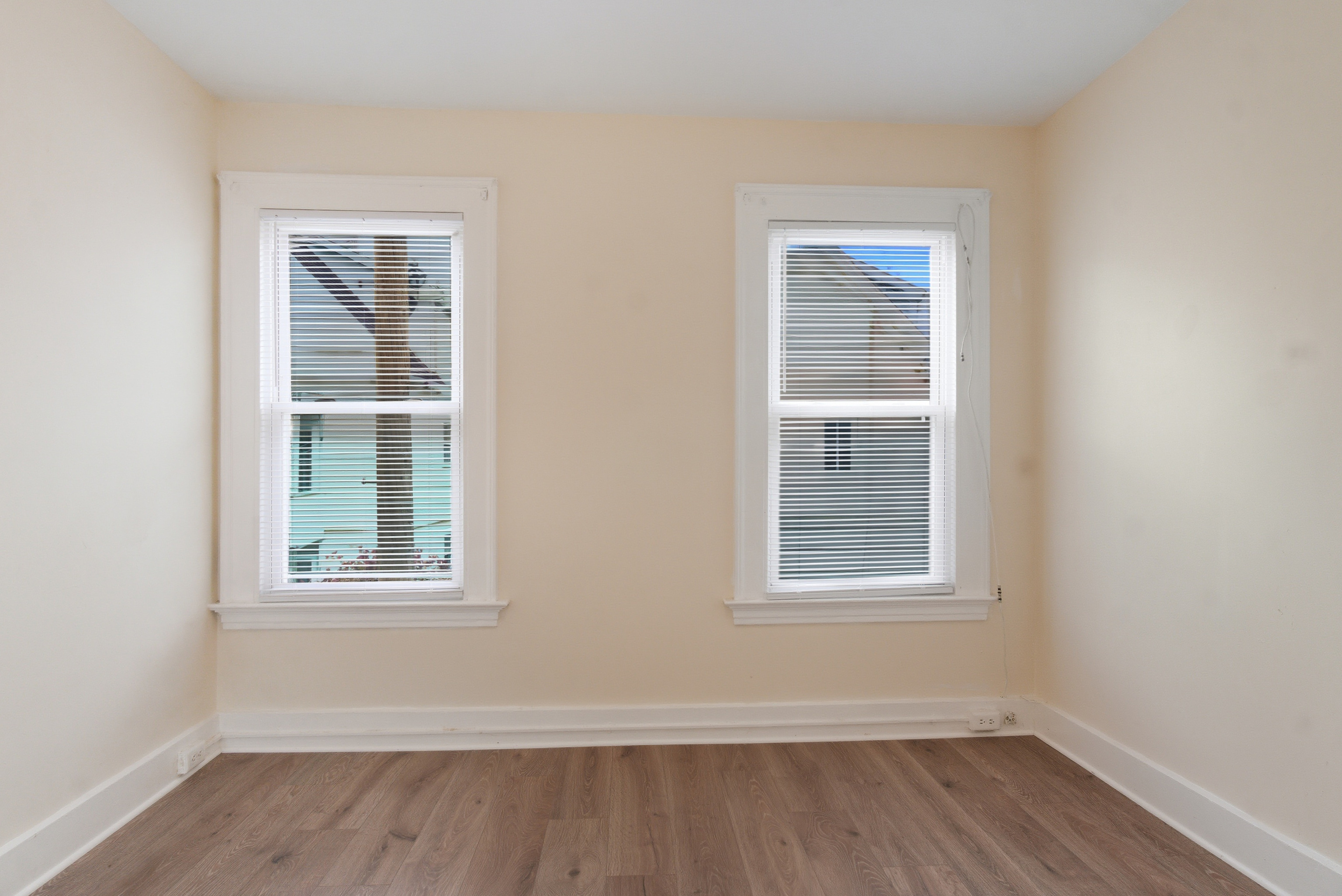 46 Court Street, Unit 2 West Haven, CT 06516 - Photo 7 of 9 a view of an empty room with wooden floor and a window