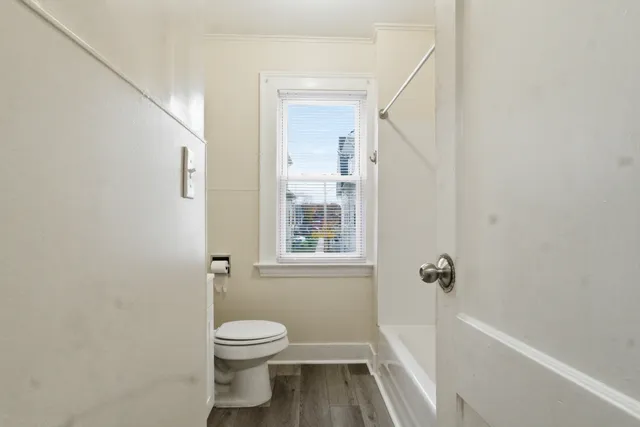 a bathroom with a toilet and a shower