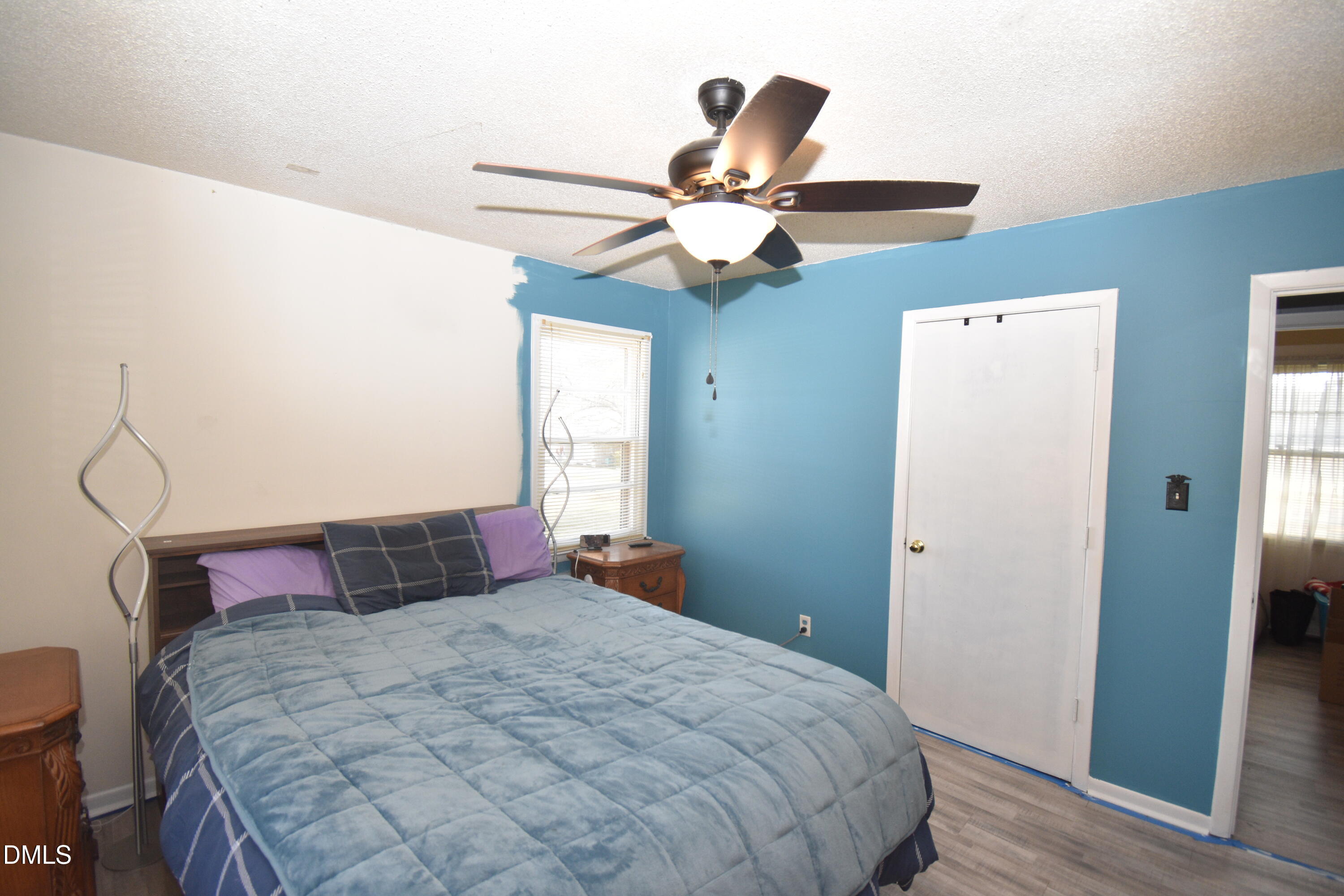 216 Sullivan Road Selma, NC 27576 - Photo 12 of 24 a bedroom with a large bed and a chandelier