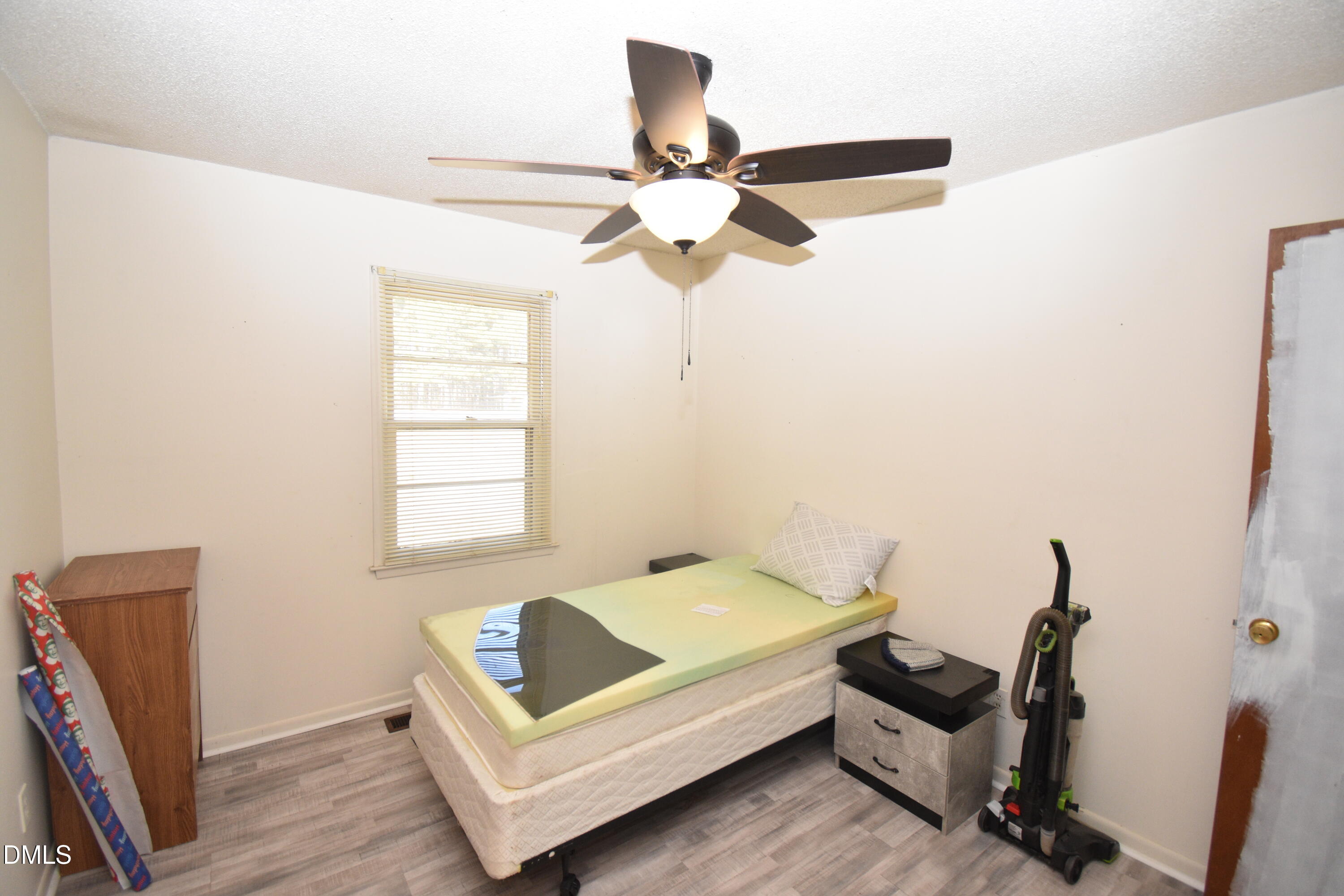 216 Sullivan Road Selma, NC 27576 - Photo 13 of 24 a bedroom with furniture and a window