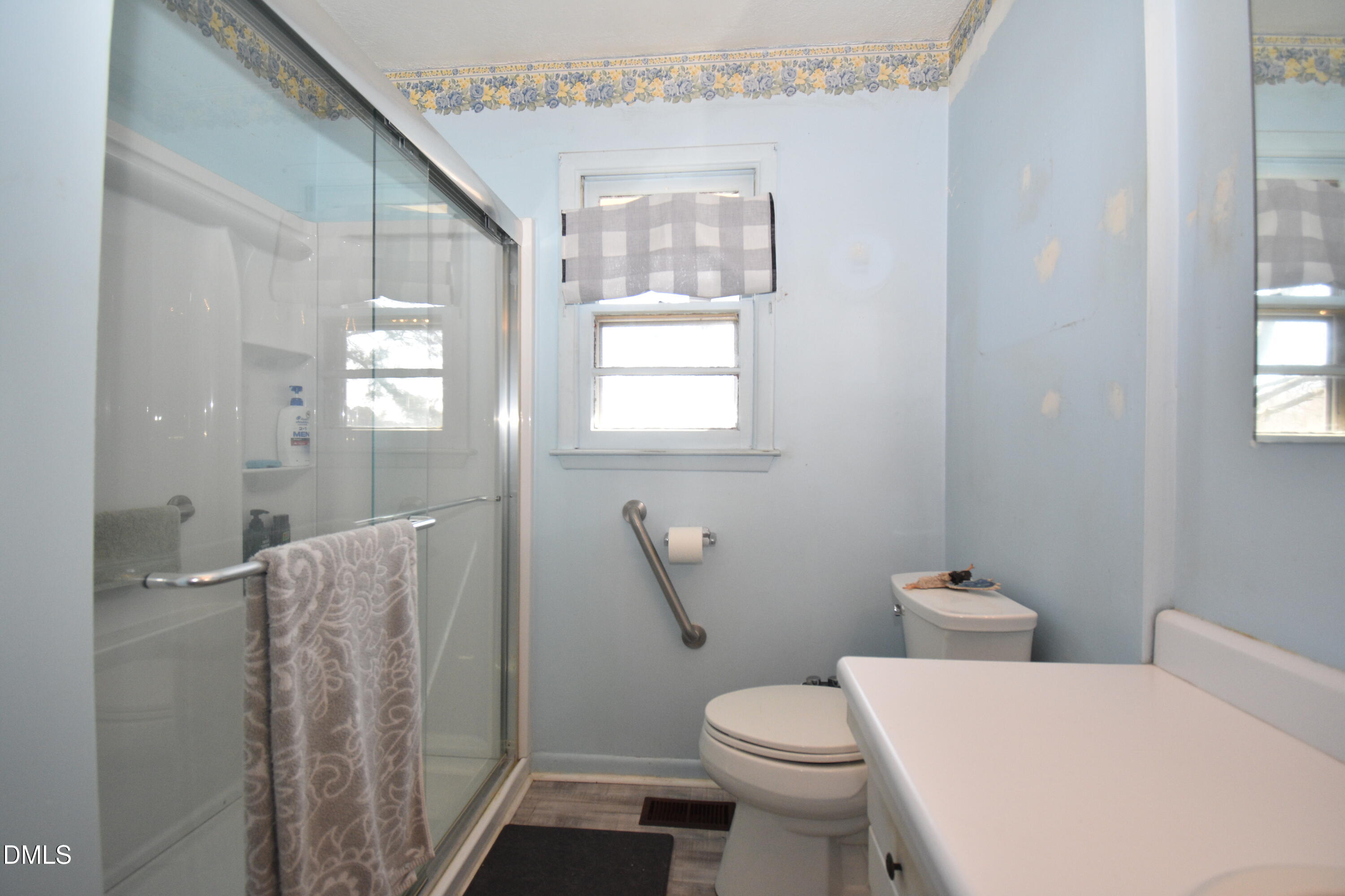 216 Sullivan Road Selma, NC 27576 - Photo 15 of 24 a bathroom with a toilet a sink and a window