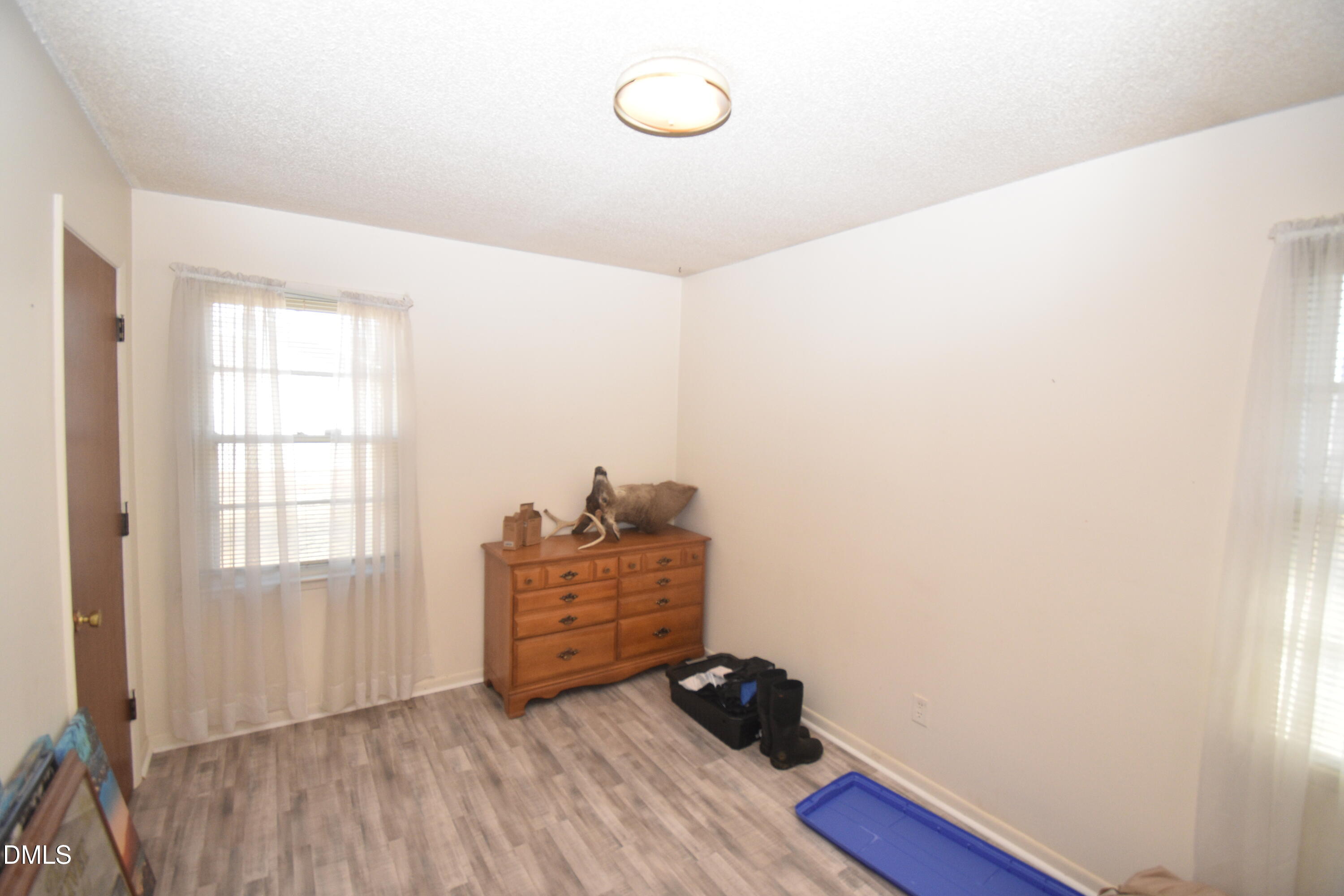 216 Sullivan Road Selma, NC 27576 - Photo 17 of 24 a view of room with hardwood floor and window