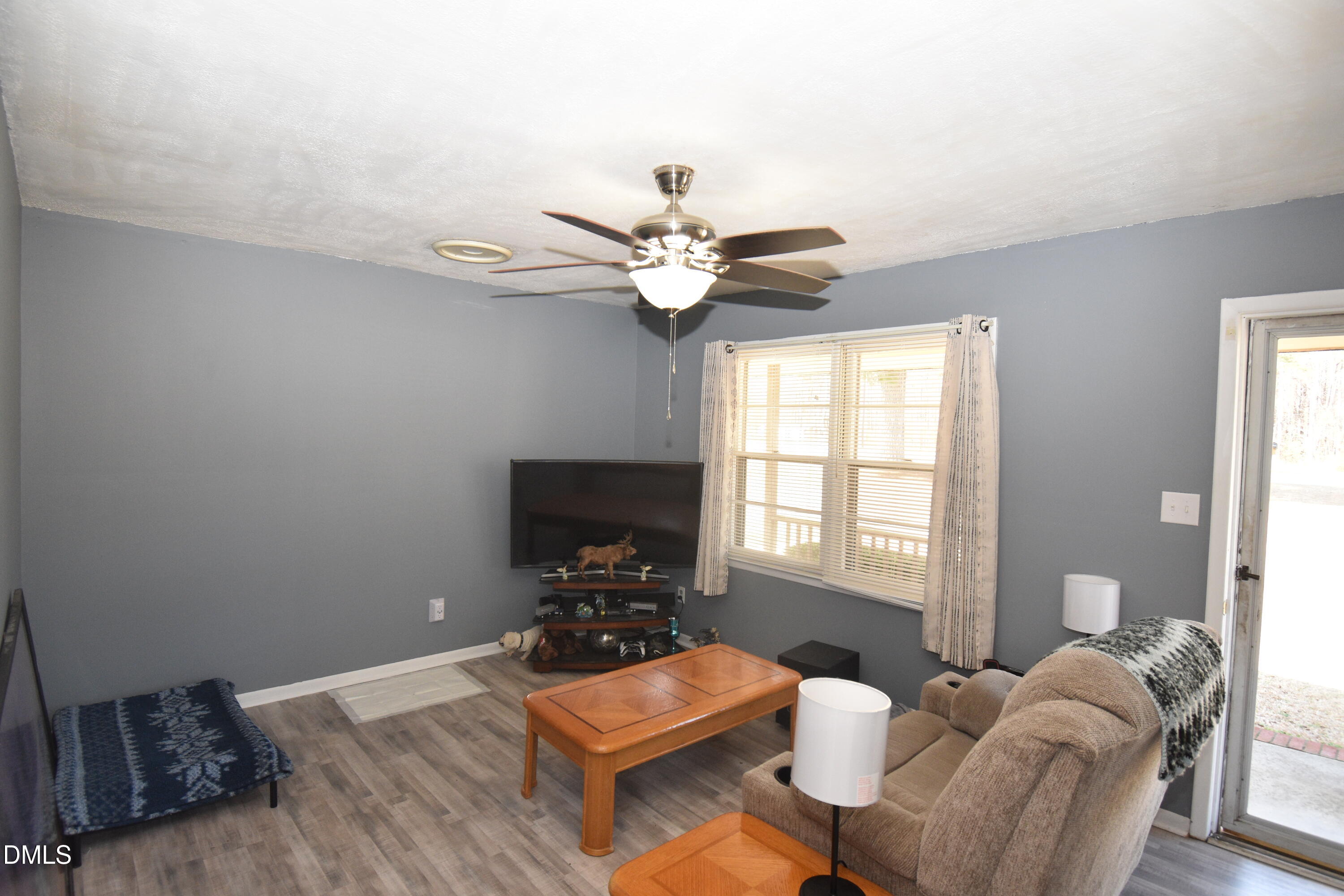 216 Sullivan Road Selma, NC 27576 - Photo 5 of 24 a living room with furniture chandelier and a window
