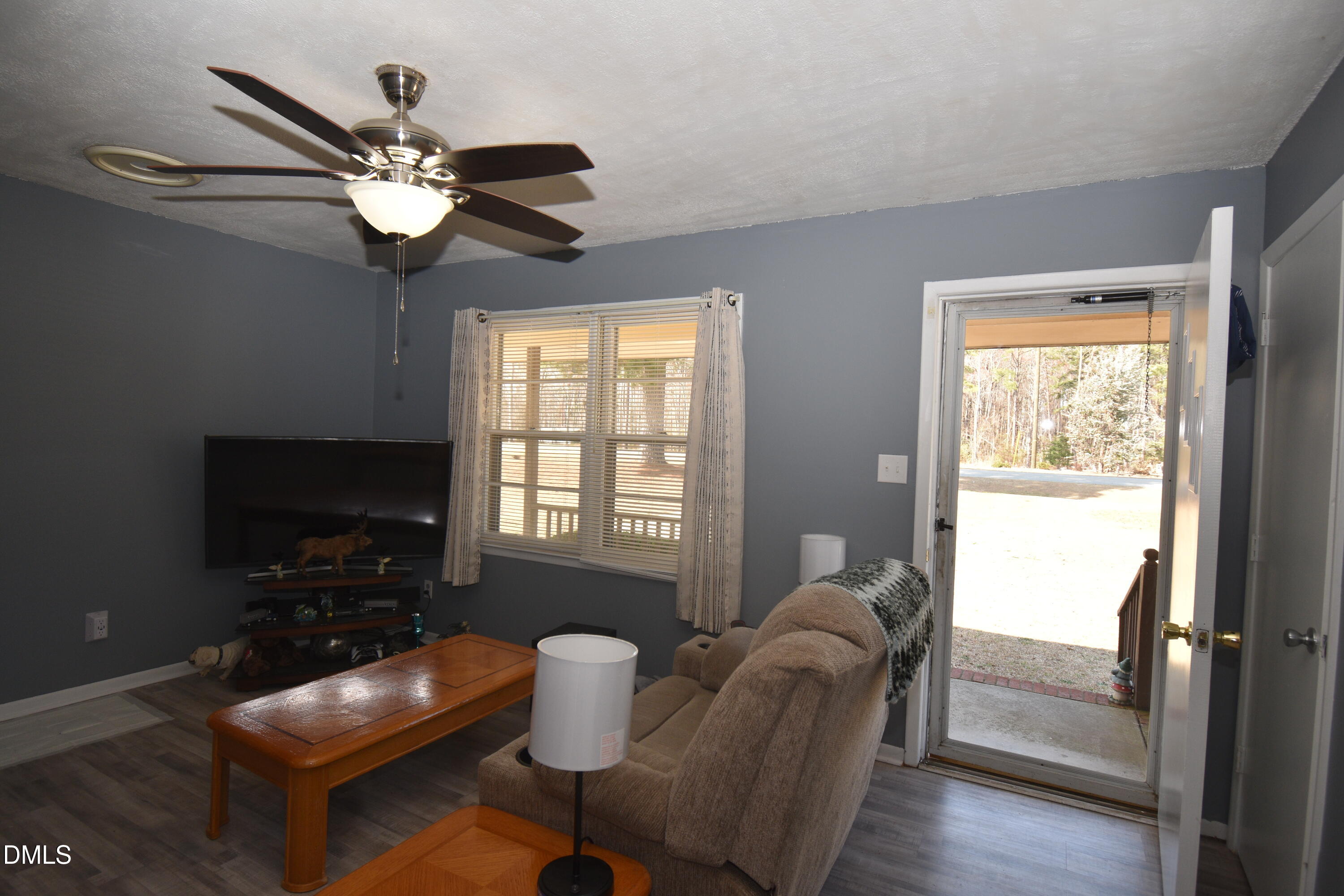 216 Sullivan Road Selma, NC 27576 - Photo 6 of 24 a living room with furniture a flat screen tv and a window