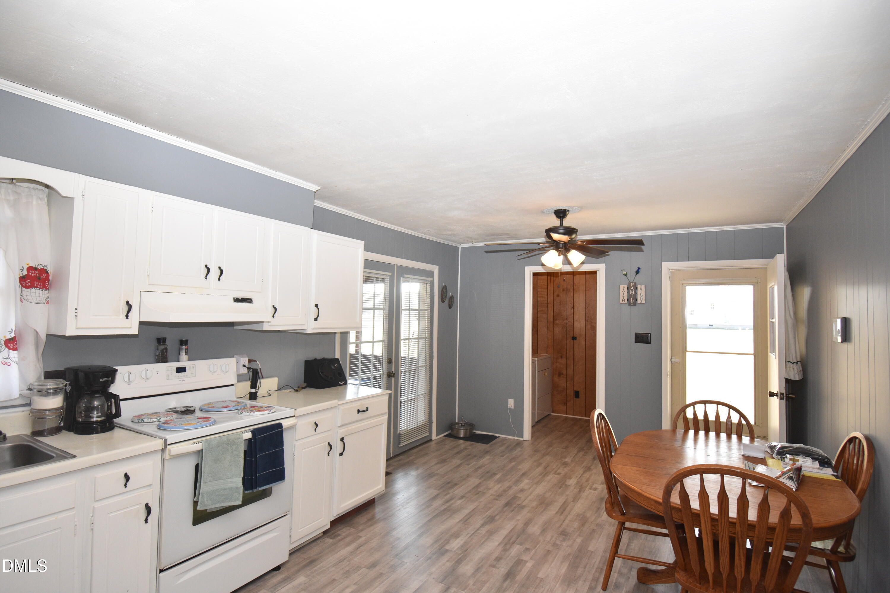 216 Sullivan Road Selma, NC 27576 - Photo 8 of 24 a kitchen with a stove cabinets and wooden floor