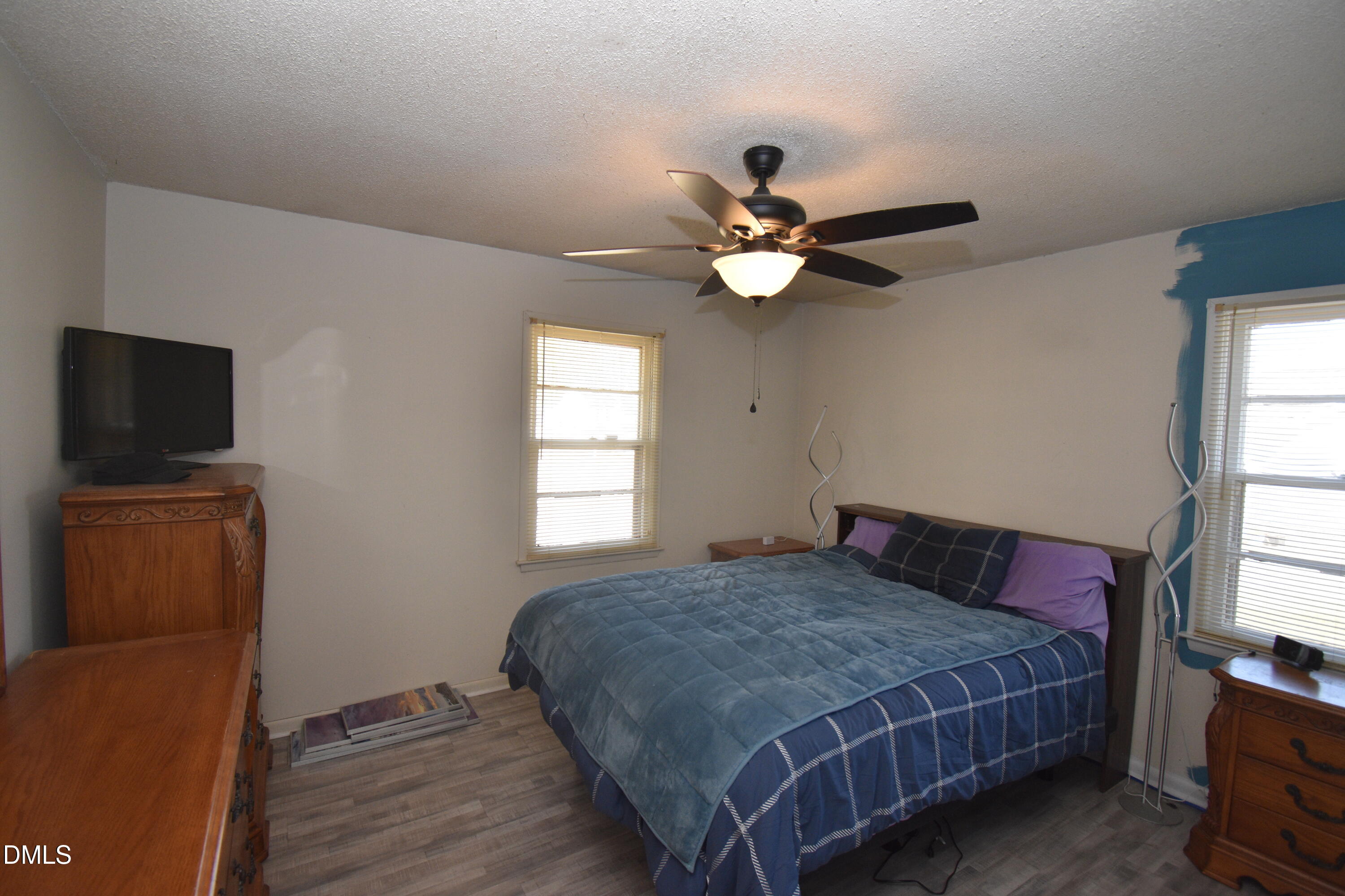 216 Sullivan Road Selma, NC 27576 - Photo 10 of 24 a bedroom with a bed window and a flat screen tv